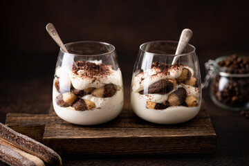 tiramisu dessert in a glass on a dark background