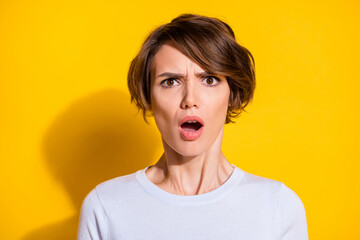 Photo of mad offended young woman staring open mouth wear white t-shirt isolated yellow color background