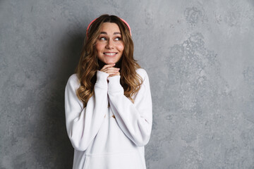 Cheerful lovely girl listening to music with headphones