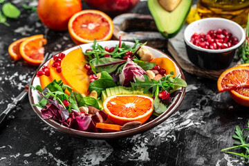 Healthy vegetable buddha bowl lunch avocado, blood orange, broccoli, watermelon radish, spinach, quinoa, pumpkin seeds. space for text. top view