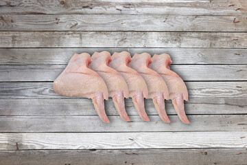 Chicken wings on a wooden background. Chicken meat on a wooden background.