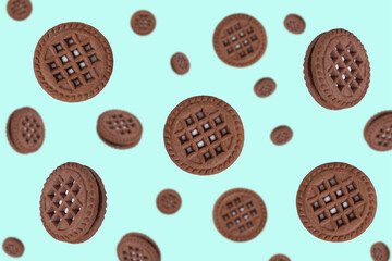 Round chocolate cookies on a mint background. Falling cookies. cookies background