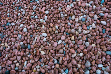 Natural beach pebbles on the beach as a natural background