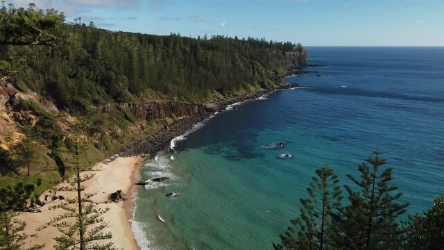 Bottom to top tilt panning motion view of the beach and beautiful scenery of Anson Bay on the west west coast of Norfolk Island, Australia