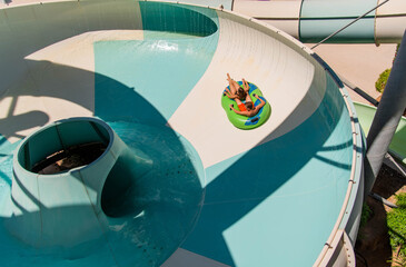 Girl and boy in water Park. Fun on the water. Teen girl and boy having fun in the water slider ....