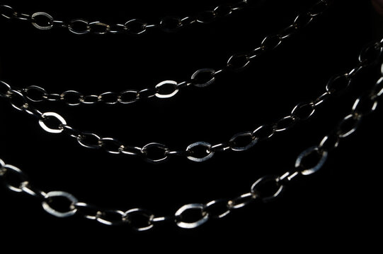 Metallic silver chains isolated on a black background