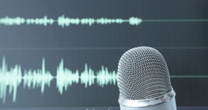 Recording session with professional microphone in front of screen with audio waveform. Podcast, voice recording, singer, dubbing.