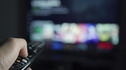 hand holding smart TV remote control watch movies at night