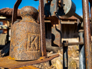 close up rusty equal arm scales with kilogram bar
