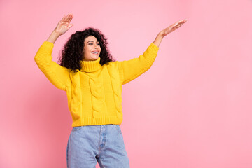 Photo of young hispanic girl happy positive smile look empty space enjoy music dance isolated over pink color background