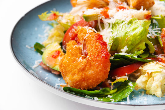 Macro photo of fresh tasty and delicious salad with crispy shrimps.