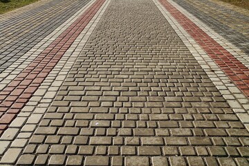 Fototapeta premium Pedestrian walkway covered with decorative tiles, background