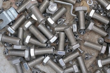 pile of nut and bolts on a dirty floor