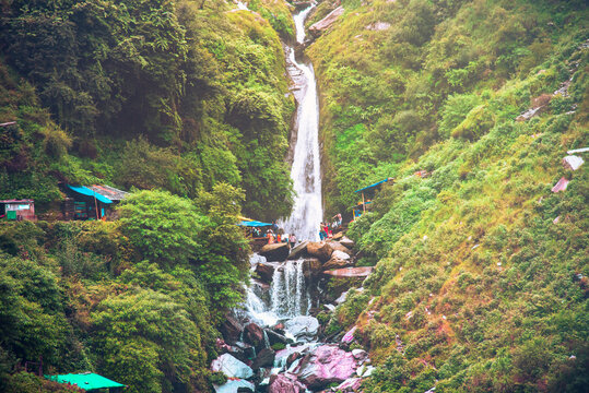 Majestic landscape of Bhagsu Nag waterfall and green forest around at Mcleodganj, Himachal Pradesh, India.