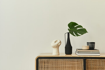 Modern scandinavian home interior with design wooden commode, tropical leaf in vase, books and...