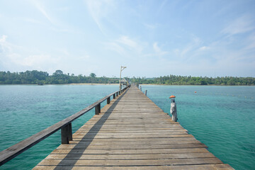 Long wooden bridge on the sea in beautiful tropical island, Thailand.