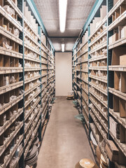 Fototapeta premium many shelves filled with spare parts stand in the parts store of a car repair shop