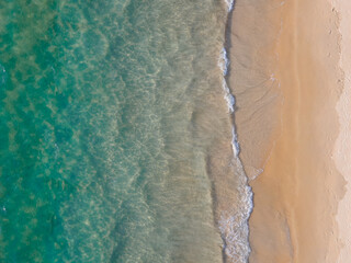 (Top view) Aerial view drone over beach sea. Beautiful sea waves. Beach sand and amazing sea. Summer sunset seascape. Phuket Thailand Beach. Water texture. Top view of the fantastic natural sunsets