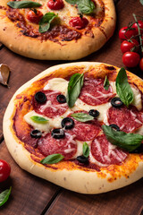 Freshly baked pizza with tomatoes and basil on a wooden board