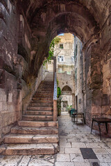 Ancient stone arch passage with steps in old town Split in Croatia