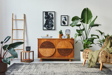 Stylish scandinavian composition of living room with design commode, black mock up poster frames,...