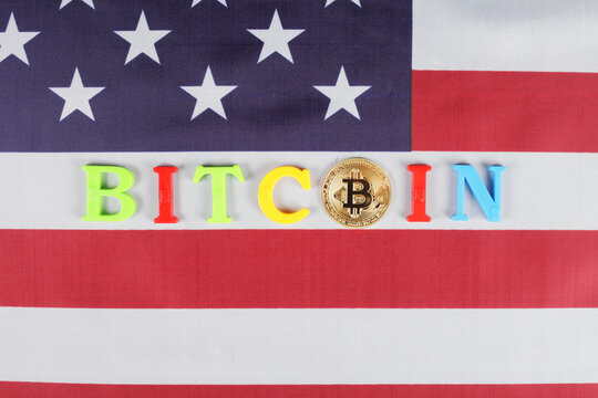 Golden bitcoin, inscription bitcoin on the flag of the United States, place for your text, selective focus, top wiev
