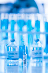 Bottle of COVOD-19 vaccine sample in a laboratory. Idea for researching and lab tests for coronavirus curing.