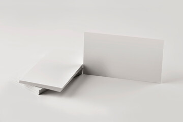 Mockup of a stack of blank business cards on a gray table close up.