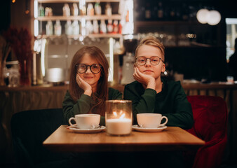Portrait of beautiful young girl and boy sitting in cafe . Kids love