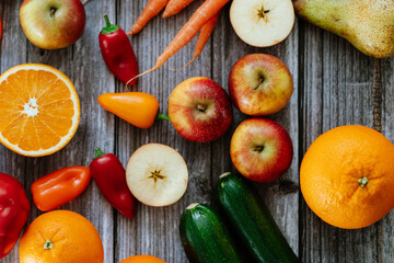 Fresh, healthy, colorful composition from various raw, seasonal fruits and vegetables, food still life on a wooden background