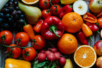 Fresh, healthy, colorful composition from various raw, seasonal fruits and vegetables, food still life on a wooden background