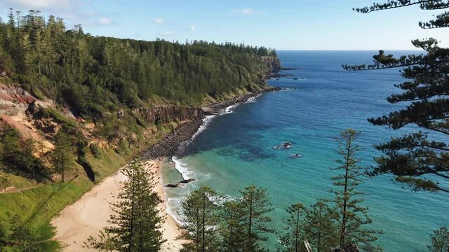 Right to left panning motion of the beach and beautiful scenery of Anson Bay on the west west coast of Norfolk Island, Australia