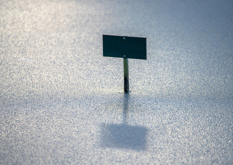 Blank sign on frozen water