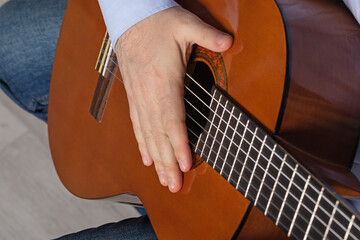 man shows guitar chords. Playing guitar close up