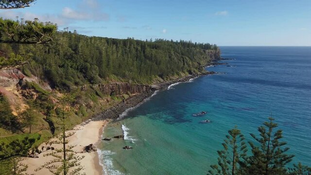 Top to bottom tilt panning motion view of the beach and beautiful scenery of Anson Bay on the west west coast of Norfolk Island, Australia
