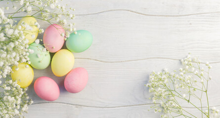 Happy Easter card with multicolored eggs and flowers pastel toned.