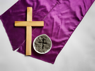 Lent Season,Holy Week and Good Friday concepts - photo of wooden cross and bowl of ash in vintage...