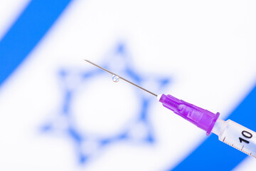 Syringe with vaccine in front of Israel flag. Concept of vaccination in Israel