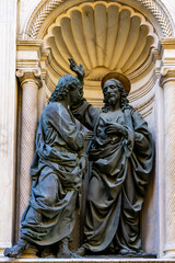 Fototapeta premium Christ and St. Thomas statues by Andrea del Verrocchio, at Orsanmichele church exterior in Florence, Italy