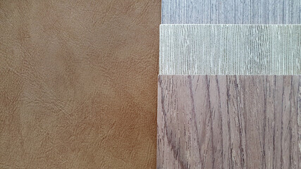 wooden laminated swatch placed on leather background. various type of wooden veneer containing ash...