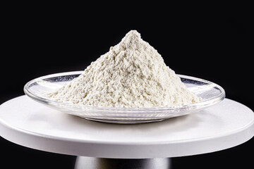 Pile of calcium sulfate on white background, known as micronized alabaster or micronized plaster