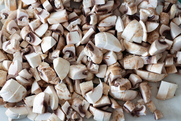 Finely chopped white champignons on the table. Ingredient