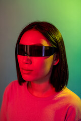 Young asian woman wearing smart glasses on colorful background - Diverse young female wearing sci-fi eye glasses isolated on background