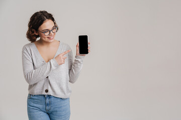 Happy beautiful young woman holding blank screen