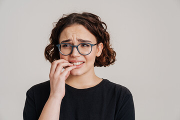 Scared worried young girl in casual clothes holding fingers