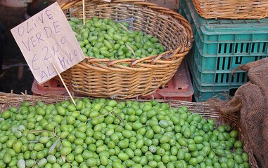 fresh green olives, green olives in a basket, olives sold in containers on the market