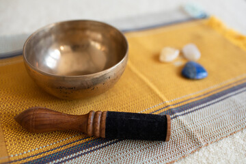 Singing bowls or Tibetan bowls and wooden mallet or stick for meditation, mindfulness, sound healing, relaxation. With some crystals (lapis lazuli, carnelian, citrine and calcite)