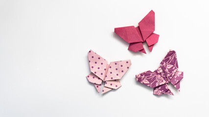 colored paper butterflies on a white background