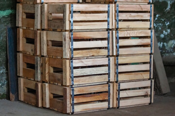 Two rows of empty wooden boxes for the release of finished products from the warehouse