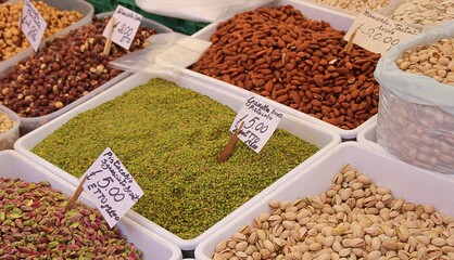 shelled pistachios, peeled pistachios and pieces of crushed pistachios, almonds and hazelnuts in the market, nut stall, Sicilian street market
